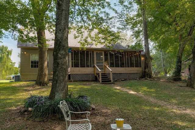 204 Riverside Dr, Pangburn, AR 72121 - back of property with a sunroom, central air condition unit, a yard, and roof with shingles