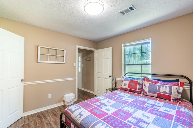 204 Riverside Dr, Pangburn, AR 72121 - bedroom with wood finished floors, a textured ceiling, and baseboards