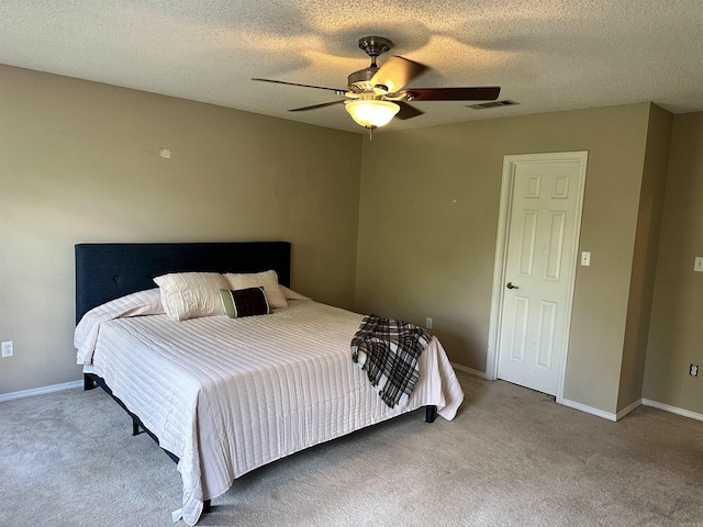 bedroom featuring carpet floors, ceiling fan, a textured ceiling, and baseboards
