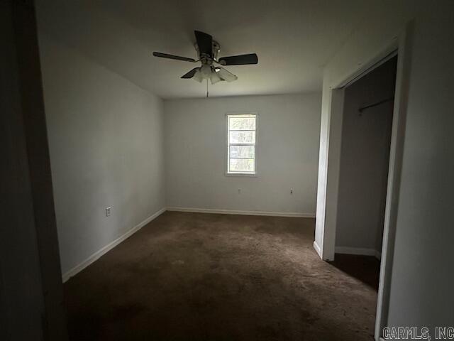 unfurnished bedroom with carpet floors, baseboards, and ceiling fan