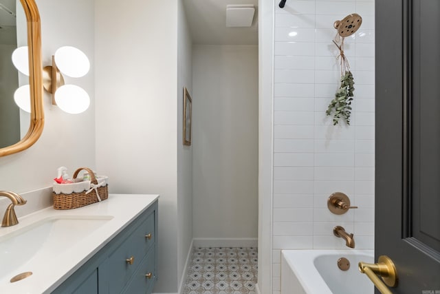 bathroom featuring vanity, baseboards, bathtub / shower combination, and tile patterned floors