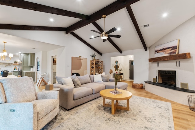 living room with ceiling fan, wood finished floors, a chandelier, and recessed lighting