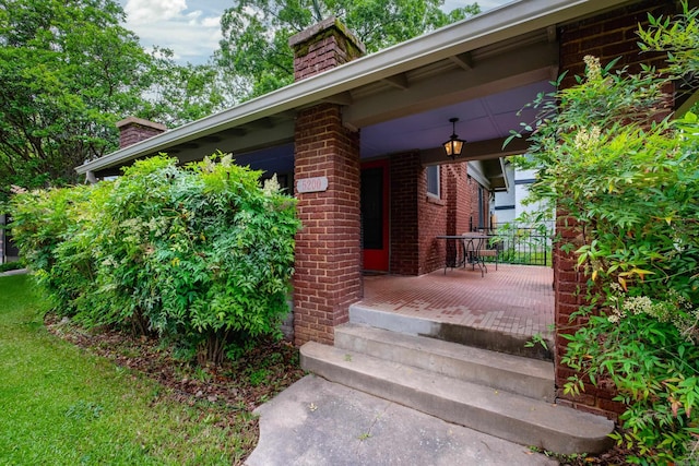 5200 I St, Little Rock, AR 72205 - view of side of home featuring a chimney, a porch, and brick siding