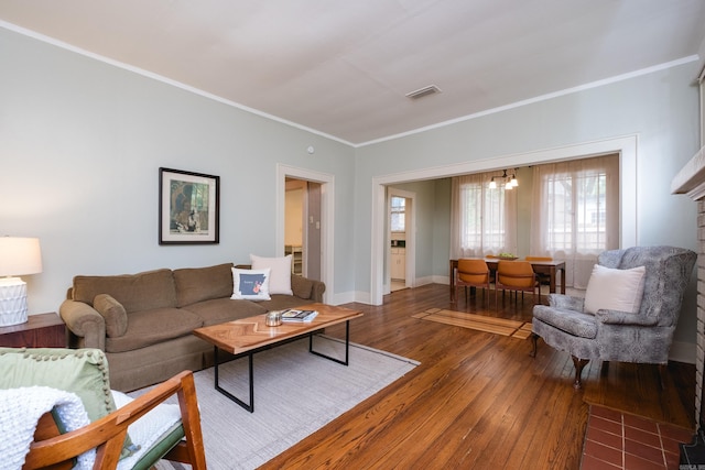 5200 I St, Little Rock, AR 72205 - living area with hardwood / wood-style flooring, ornamental molding, a chandelier, and baseboards