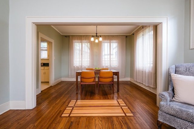 5200 I St, Little Rock, AR 72205 - dining space featuring wood finished floors, baseboards, a chandelier, and ornamental molding