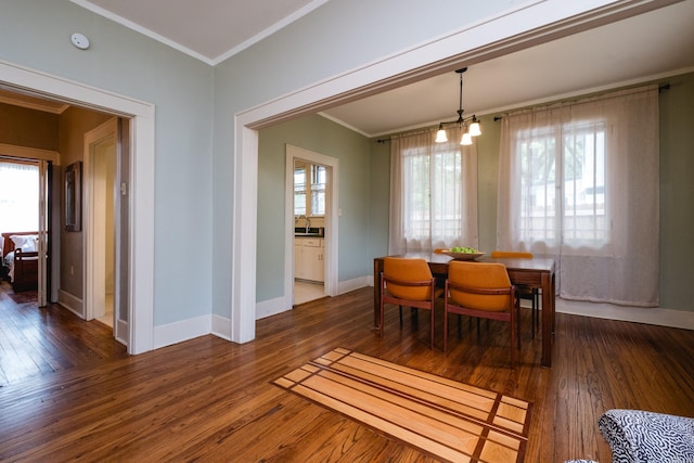 5200 I St, Little Rock, AR 72205 - dining room featuring hardwood / wood-style flooring, a chandelier, crown molding, baseboards, and healthy amount of natural light