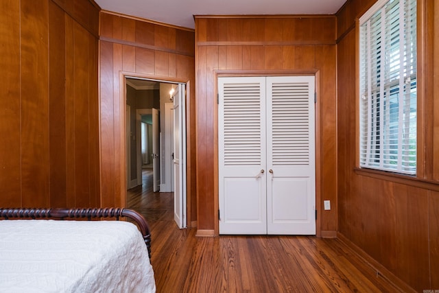 5200 I St, Little Rock, AR 72205 - bedroom featuring multiple windows, wood finished floors, wooden walls, a closet, and baseboards