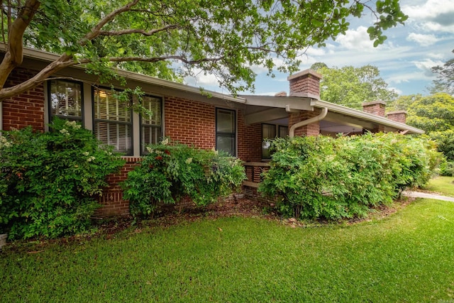 5200 I St, Little Rock, AR 72205 - view of side of property featuring a chimney, brick siding, and a lawn