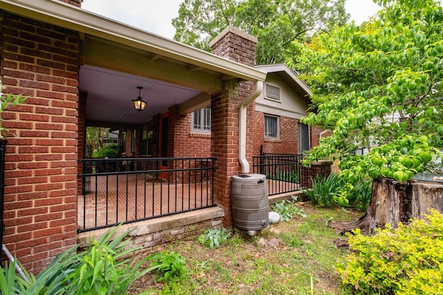 5200 I St, Little Rock, AR 72205 - view of side of property with brick siding, a chimney, and fence