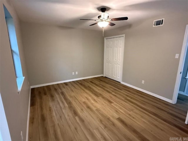 3705 E 6th St, Russellville, AR 72802 - unfurnished bedroom featuring baseboards, a closet, wood finished floors, and a ceiling fan