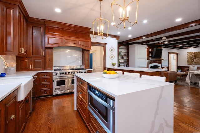 kitchen featuring range with two ovens, dark wood finished floors, a center island, open floor plan, and recessed lighting