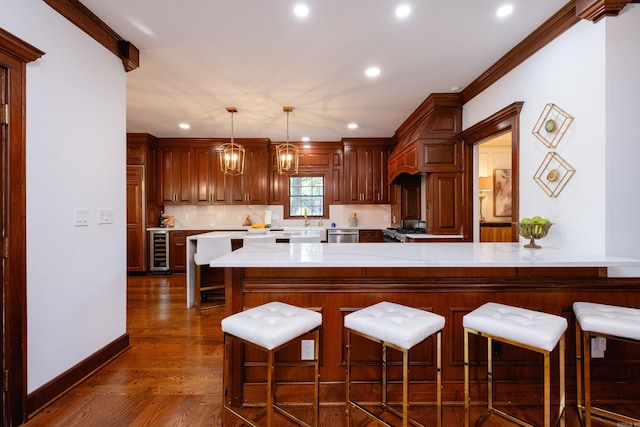 kitchen featuring beverage cooler, stove, recessed lighting, dark wood-type flooring, and light countertops
