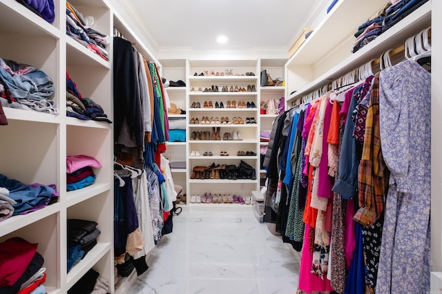 spacious closet featuring marble finish flooring