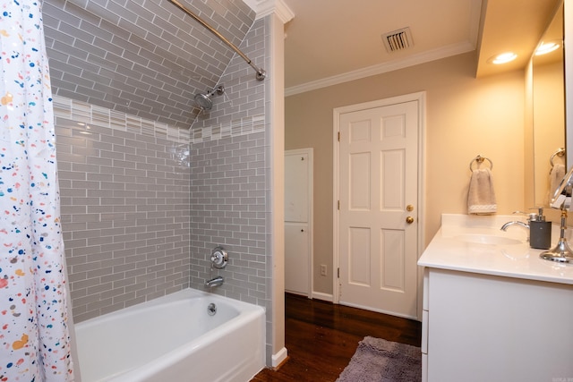 full bathroom with wood finished floors, ornamental molding, shower / tub combo with curtain, and vanity