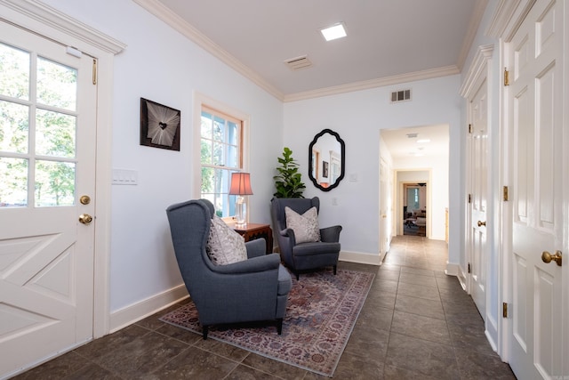 sitting room with ornamental molding, baseboards, and dark tile patterned flooring