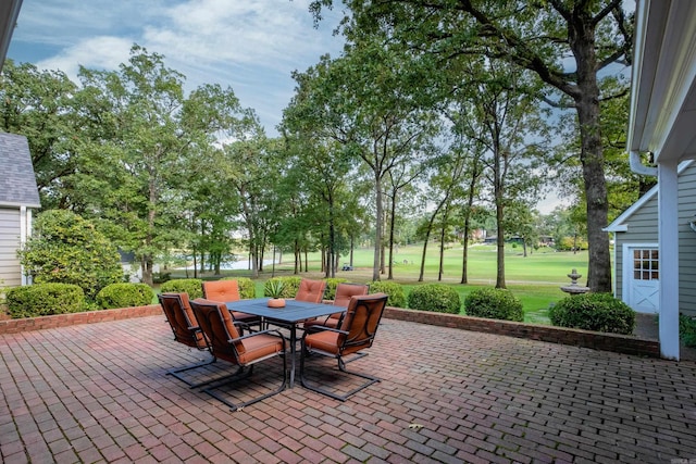 view of patio / terrace featuring outdoor dining area and view of golf course