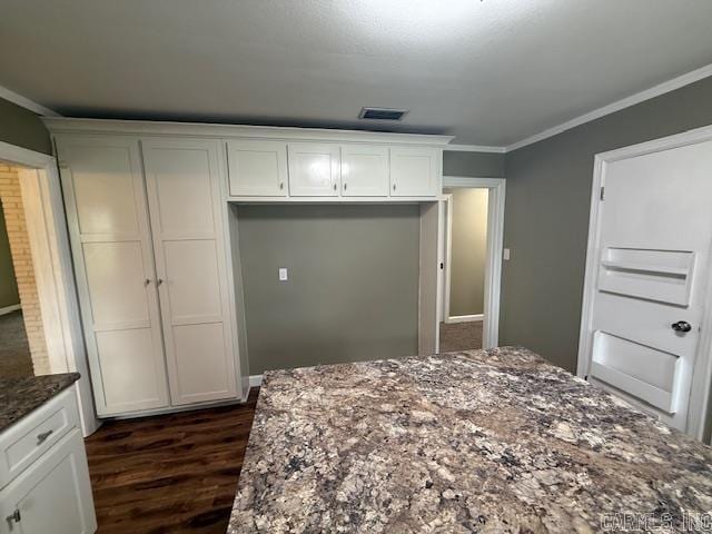 307 E 5th St, Carlisle, AR 72024 - bedroom with dark wood-type flooring, ornamental molding, and a closet