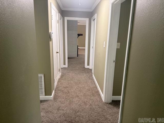 307 E 5th St, Carlisle, AR 72024 - hallway featuring carpet, ornamental molding, attic access, and baseboards