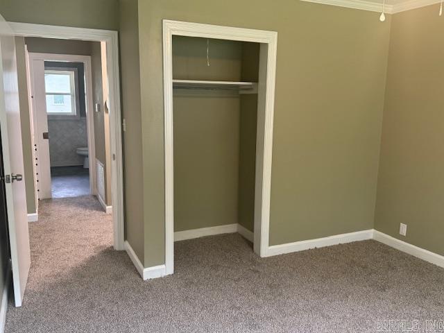 307 E 5th St, Carlisle, AR 72024 - unfurnished bedroom with carpet, a closet, baseboards, and ornamental molding
