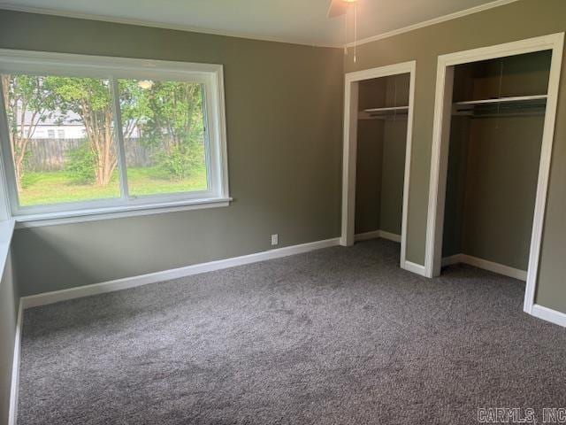307 E 5th St, Carlisle, AR 72024 - unfurnished bedroom featuring multiple closets, carpet floors, baseboards, and ornamental molding