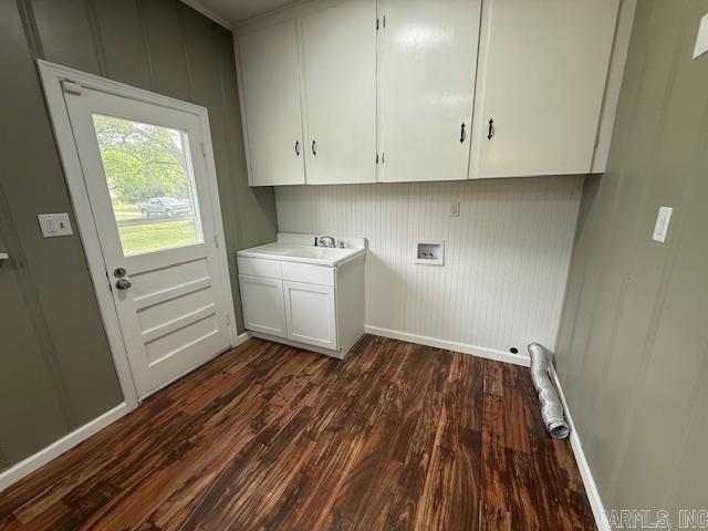 307 E 5th St, Carlisle, AR 72024 - laundry room featuring cabinet space, washer hookup, dark wood finished floors, baseboards, and a decorative wall