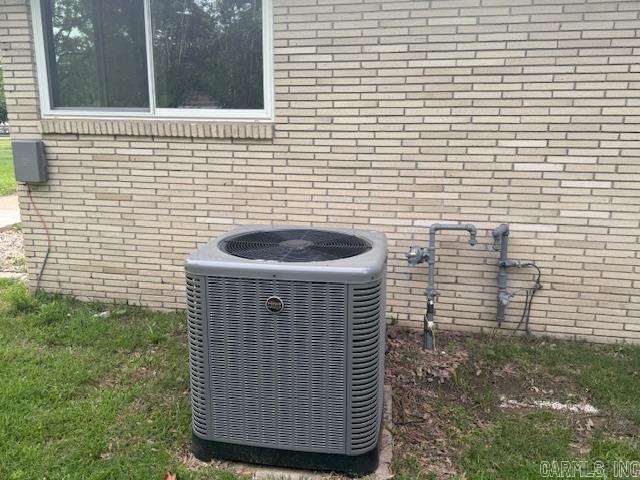 307 E 5th St, Carlisle, AR 72024 - exterior view of central air condition unit and brick siding