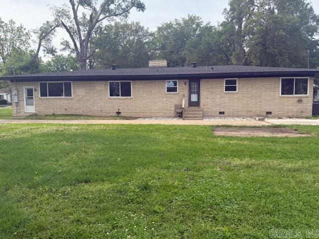 307 E 5th St, Carlisle, AR 72024 - back of property with entry steps, crawl space, a lawn, and brick siding