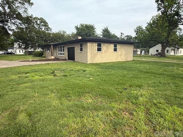 307 E 5th St, Carlisle, AR 72024 - view of home's exterior with a yard
