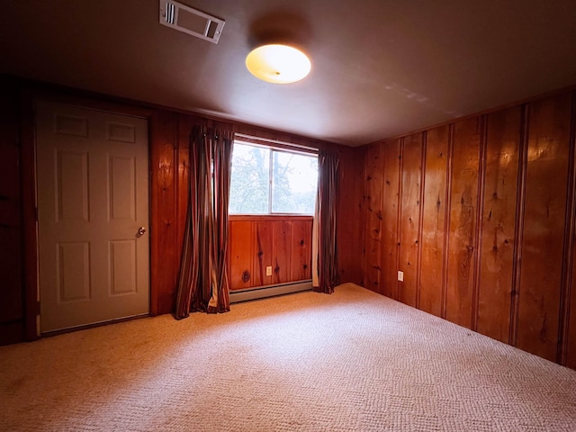 96 E Lakeshore Dr, Cherokee Village, AR 72529 - unfurnished bedroom with a baseboard heating unit, carpet, and wood walls
