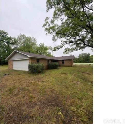 5101 Judy Rd, North Little Rock, AR 72117 - view of green lawn with a garage