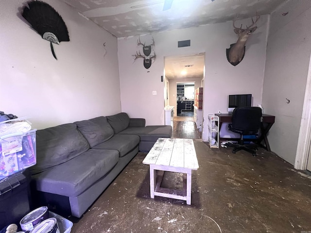 320 E 5th St, Rector, AR 72461 - living area with unfinished concrete floors and a desk