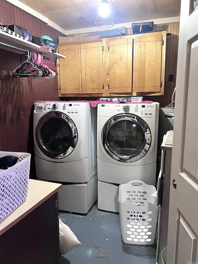 320 E 5th St, Rector, AR 72461 - laundry area featuring cabinet space, washing machine and clothes dryer, and wooden walls
