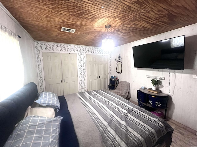 320 E 5th St, Rector, AR 72461 - bedroom featuring wooden ceiling, two closets, and wood walls