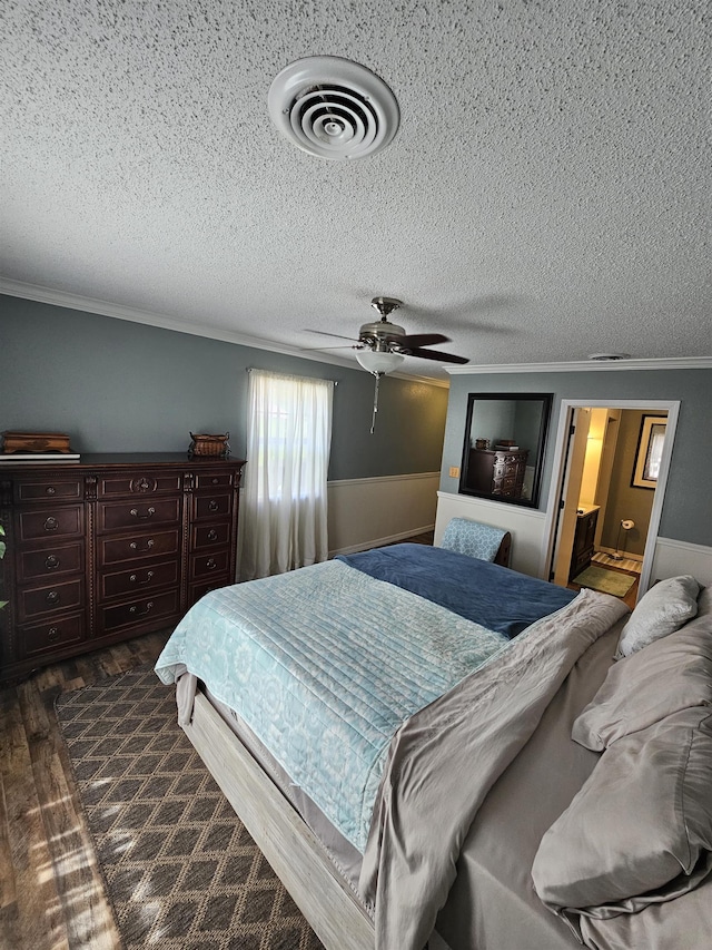 bedroom with crown molding, dark wood-type flooring, a textured ceiling, and ceiling fan