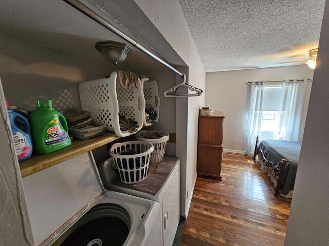 clothes washing area featuring independent washer and dryer, wood finished floors, and a textured ceiling