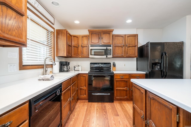 36 Lequita Pl, Hot Springs Village, AR 71909 - kitchen featuring black appliances, a sink, brown cabinetry, light wood-style floors, and recessed lighting