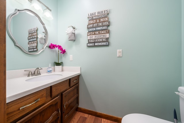 36 Lequita Pl, Hot Springs Village, AR 71909 - bathroom with toilet, wood finished floors, vanity, and baseboards