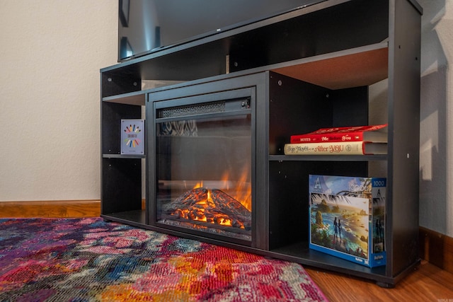 36 Lequita Pl, Hot Springs Village, AR 71909 - detailed view of wood finished floors, baseboards, and a lit fireplace