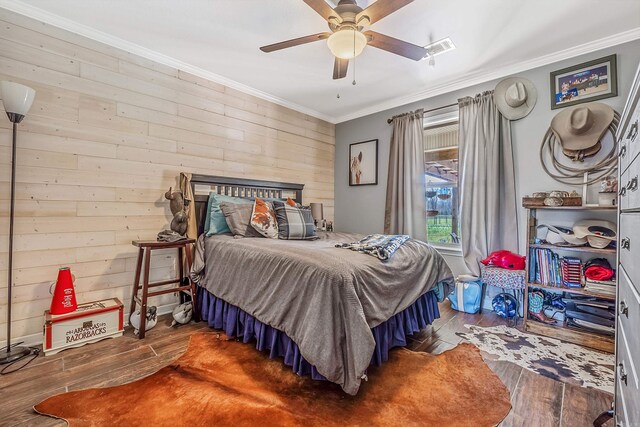 15 Eastwood Dr, Ward, AR 72176 - bedroom with ornamental molding, hardwood / wood-style flooring, wooden walls, and a ceiling fan