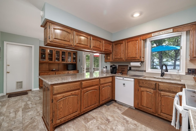 3 Tenerife Way, Hot Springs Village, AR 71909 - kitchen featuring white appliances, a sink, brown cabinets, a peninsula, and light stone counters