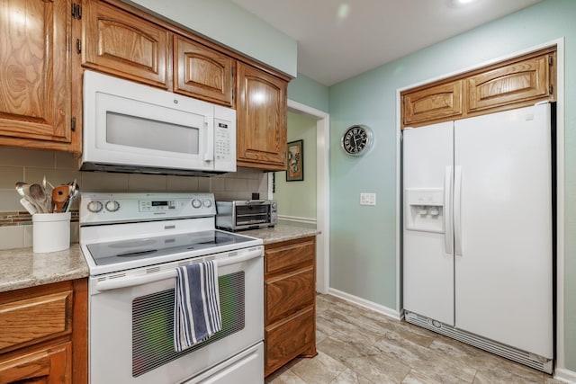 3 Tenerife Way, Hot Springs Village, AR 71909 - kitchen featuring white appliances, tasteful backsplash, light countertops, brown cabinetry, and baseboards