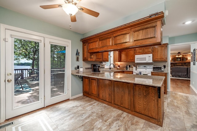 3 Tenerife Way, Hot Springs Village, AR 71909 - kitchen with white appliances, brown cabinets, a sink, a peninsula, and a ceiling fan