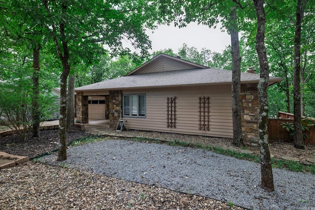 3 Tenerife Way, Hot Springs Village, AR 71909 - view of front of home featuring a garage, a chimney, stone siding, gravel driveway, and a shingled roof