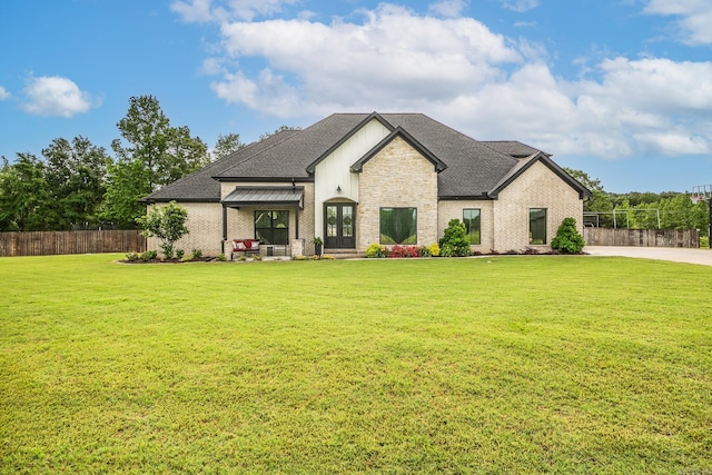 view of front of home with french doors, brick siding, and roof with shingles