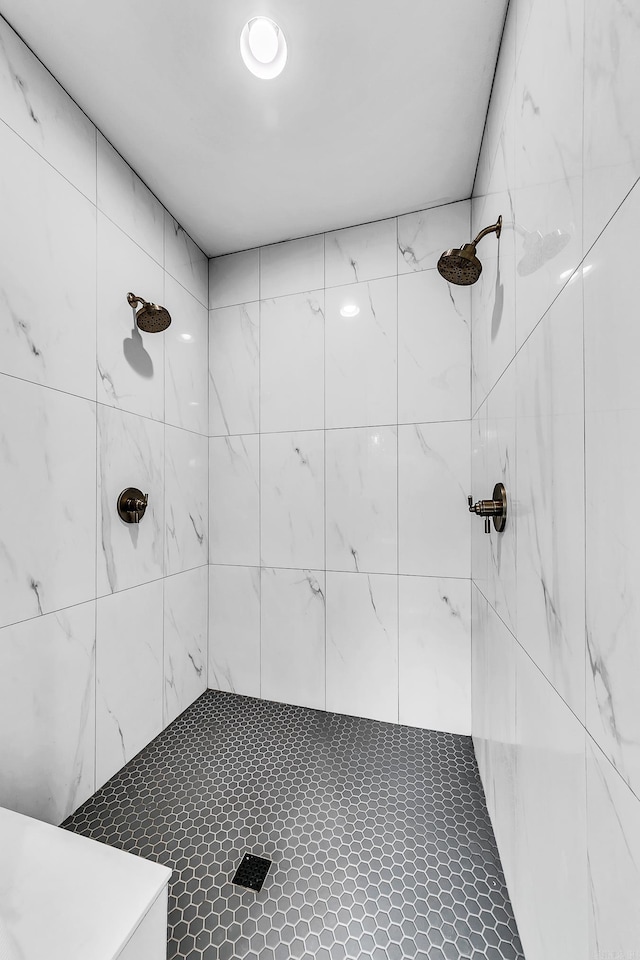 full bath with a tile shower