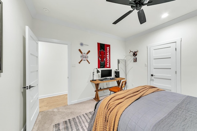 carpeted bedroom with a ceiling fan, baseboards, and an office area