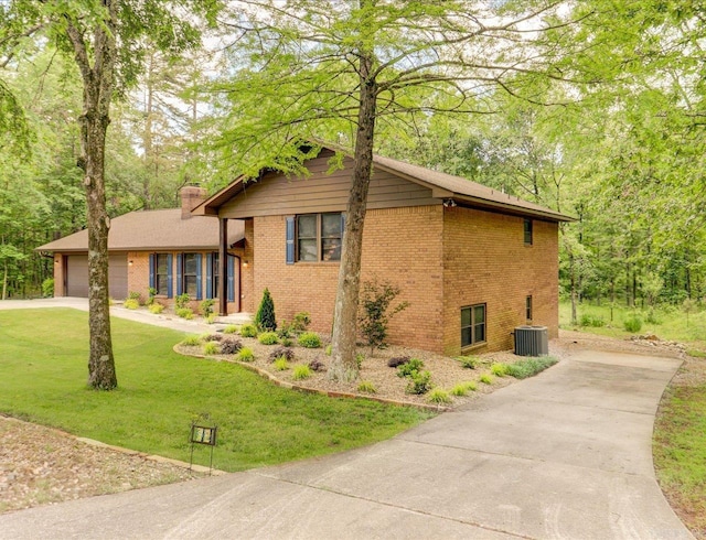 72 Pintuerero Way, Hot Springs Village, AR 71909 - view of front facade with concrete driveway, brick siding, a chimney, central AC, and a front yard
