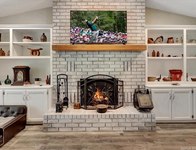 72 Pintuerero Way, Hot Springs Village, AR 71909 - living room with lofted ceiling, wood finished floors, and a fireplace