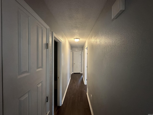 2608 Timbermist Cir, Benton, AR 72015 - corridor with a textured ceiling, baseboards, and dark wood-style flooring