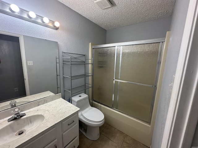 2608 Timbermist Cir, Benton, AR 72015 - full bathroom with a textured ceiling, vanity, tile patterned flooring, toilet, and a textured wall